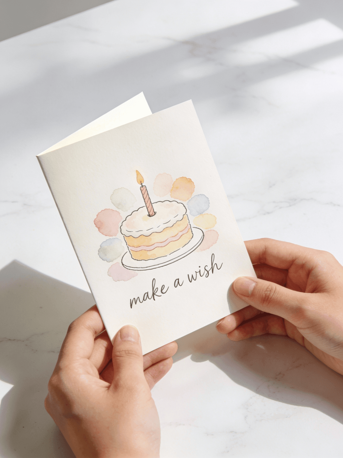 A birthday card with a watercolour cake